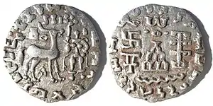 Silver coin of the Kuninda Kingdom, c. 1st century BCE. These coins followed the Indo-Greek module.Obv: Deer standing right, crowned by two cobras, attended by Lakshmi holding a lotus flower. Legend in Prakrit (Brahmi script, from left to right): Rajnah Kunindasya Amoghabhutisya maharajasya ("Great King Amoghabhuti, of the Kunindas").Rev: Stupa surmounted by the Buddhist symbol triratna, and surrounded by a swastika, a "Y" symbol, and a tree in railing. Legend in Kharoshti script, from right to left: Rana Kunidasa Amoghabhutisa Maharajasa, ("Great King Amoghabhuti, of the Kunindas"). of Kuninda Kingdom