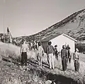 Students of the Little Outfit Schoolhouse raising the US flag in 1943