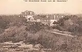 A black-and-white postcard of a hotel in a forest
