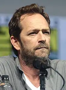 Perry sitting behind a microphone