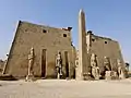 Entrance of the Luxor Temple, western façade; a pair of obelisks usually stood in front of a pylon; the 2nd obelisk (the Luxor Obelisk, 23 metres (75&nbsp;ft) high, not shown) had been moved to France.