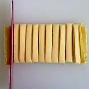 Sheets of pasta are folded and sliced into noodles