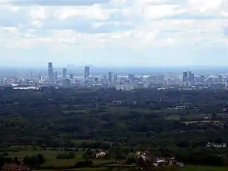 View of Manchester from Hartshead Pike, 8 miles (13&nbsp;km) away with Fiddlers Ferry Power Station beyond,  27 miles (43&nbsp;km) away.