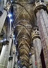 Vaulted ceiling and  column capitals containing statues