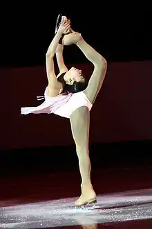 Variation with the hands on the boot instead of on the skate blade(Mirai Nagasu, 2008)