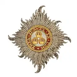 Civil Knight Grand Cross Star of The Most Honourable Order of the Bath: 'Rays of silver issuing from a centre and charged with three Imperial Crowns, one and two, within a circle gules whereon inscribed the motto of the Order in gold'.mw-parser-output cite.citation{font-style:inherit;word-wrap:break-word}.mw-parser-output .citation q{quotes:"\"""\"""'""'"}.mw-parser-output .citation:target{background-color:rgba(0,127,255,0.133)}.mw-parser-output .id-lock-free.id-lock-free a{background:url("//upload.wikimedia.org/wikipedia/commons/6/65/Lock-green.svg")right 0.1em center/9px no-repeat}body:not(.skin-timeless):not(.skin-minerva) .mw-parser-output .id-lock-free a{background-size:contain}.mw-parser-output .id-lock-limited.id-lock-limited a,.mw-parser-output .id-lock-registration.id-lock-registration a{background:url("//upload.wikimedia.org/wikipedia/commons/d/d6/Lock-gray-alt-2.svg")right 0.1em center/9px no-repeat}body:not(.skin-timeless):not(.skin-minerva) .mw-parser-output .id-lock-limited a,body:not(.skin-timeless):not(.skin-minerva) .mw-parser-output .id-lock-registration a{background-size:contain}.mw-parser-output .id-lock-subscription.id-lock-subscription a{background:url("//upload.wikimedia.org/wikipedia/commons/a/aa/Lock-red-alt-2.svg")right 0.1em center/9px no-repeat}body:not(.skin-timeless):not(.skin-minerva) .mw-parser-output .id-lock-subscription a{background-size:contain}.mw-parser-output .cs1-ws-icon a{background:url("//upload.wikimedia.org/wikipedia/commons/4/4c/Wikisource-logo.svg")right 0.1em center/12px no-repeat}body:not(.skin-timeless):not(.skin-minerva) .mw-parser-output .cs1-ws-icon a{background-size:contain}.mw-parser-output .cs1-code{color:inherit;background:inherit;border:none;padding:inherit}.mw-parser-output .cs1-hidden-error{display:none;color:#d33}.mw-parser-output .cs1-visible-error{color:#d33}.mw-parser-output .cs1-maint{display:none;color:#2C882D;margin-left:0.3em}.mw-parser-output .cs1-format{font-size:95%}.mw-parser-output .cs1-kern-left{padding-left:0.2em}.mw-parser-output .cs1-kern-right{padding-right:0.2em}.mw-parser-output .citation .mw-selflink{font-weight:inherit}html.skin-theme-clientpref-night .mw-parser-output .cs1-maint{color:#18911F}html.skin-theme-clientpref-night .mw-parser-output .cs1-visible-error,html.skin-theme-clientpref-night .mw-parser-output .cs1-hidden-error{color:#f8a397}@media(prefers-color-scheme:dark){html.skin-theme-clientpref-os .mw-parser-output .cs1-visible-error,html.skin-theme-clientpref-os .mw-parser-output .cs1-hidden-error{color:#f8a397}html.skin-theme-clientpref-os .mw-parser-output .cs1-maint{color:#18911F}}Montague-Smith, P.W., ed. (1968). Debrett's Peerage, Baronetage, Knightage and Companionage. Kingston-upon-Thames: Kelly's Directories Ltd. p. 896.