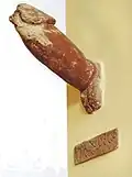 A phallus from a public alleyway in Pompeii that was 2 meteres up the side of a wall.  The inscription reads "I shat out this one phallus/prick".Tufa. Painted.