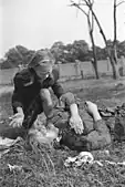 A Polish girl cries over the body of her 14-year-old sister who was strafed by German dive bombers, September 1939
