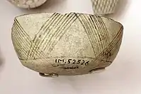 Fragment of pottery with incised and painted decor. From Tell Hassuna, 6500 - 6000 BC.