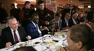 Brazilian politicians being served rodízio style