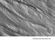 Enlargement of cliff in Kasei Valles system in previous image showing boulders and their tracks, as seen by HiRISE.  Click on image to see a boulder only 2.2 yards across (smaller than a bedroom).