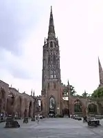 The surviving tower and steeple, which functions as a working bell tower