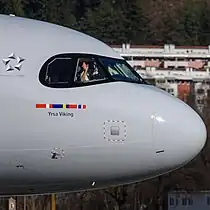 A SAS A320neo in regular livery showing the Star Alliance logo behind the cockpit windows.