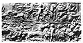 Seal from PG 1236 with inscription "Aja-Anzu", also read "A-Imdugud". Upper register: a nude hero fighting lions. Lower register: chariotter trampling an enemy, and foot soldiers escorting a naked prisoner.