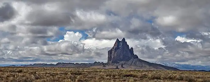 Shiprock formation in New Mexico, USA showing the 5-mille long dike radiating to the south.