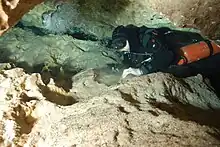 Sidemount diver in fairly tight space