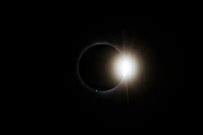 Post-totality diamond ring effect visible during the total solar eclipse of April 8, 2024, in Montreal, Quebec, viewed from Lower Field at McGill University.