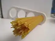 Dried spaghetti measured with a "spaghetti measure". One portion of dried pasta weighs 116&nbsp;g (4+1⁄8&nbsp;oz), twice the amount of one serving on the package (12&nbsp;mm circle or 60&nbsp;g.). The measure can portion out 1, 2, 3, or 4 servings based on the diameter of the circle.