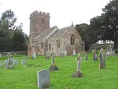 Beyond the pair of red stone semis is the village hall.