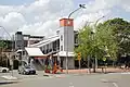 The southern entrance of St Marys train station after the metro line renovation. The tower, which once sported a functioning clock face, is now bare. In the background is a multi-storey carpark on the northern entrance of the station, beyond which lies the industrial half of the suburb.