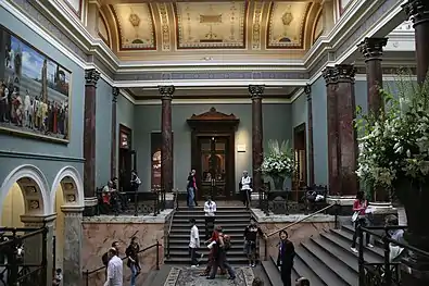 The Staircase Hall (1884–1887), designed by Sir John Taylor, in a photograph of 2007. To the left is Cimabue's Celebrated Madonna by Frederic, Lord Leighton (a loan from the Royal Collection since the 1990s).