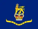 A blue flag with a crown and lion in the center, placed above a banner.