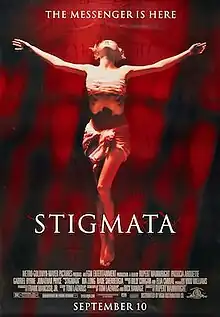 A washed out red image of a woman with arms outstretched as if being crucified