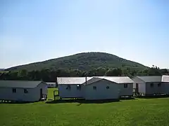 Sugarloaf Mountain viewed from the nameless hill above Elkview, with camp buildings in the foreground.