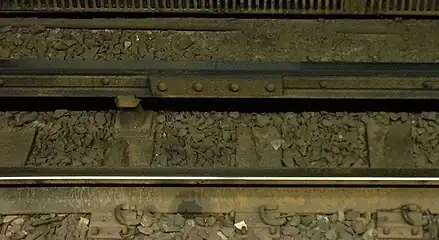 Conductor rail on the MBTA Red Line at South Station in Boston, consisting of two strips of aluminium on a steel rail to assist with heat and electrical conduction