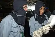YN2 Tasha McAllister reviews muster roll during "general quarters" drill aboard USS&nbsp;Harry S Truman (CVN-75).