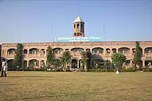 Long, two-story building with towerpunjab group of colleges