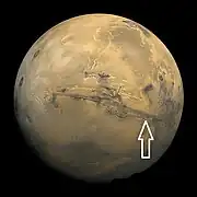 Image of disk of Mars taken by Viking.  Arrow shows location of recurrent slope lineae in following HiRISE images.