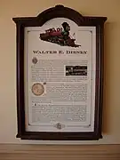 A plaque representing information about a red steam locomotive