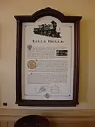 A plaque representing information about a green steam locomotive