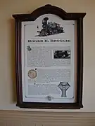A plaque representing information about a green steam locomotive