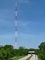 An antenna tower 1,075 feet (328&nbsp;m) tall in Atlanta, GA with its red and white aircraft warning paint visible