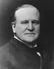 A black and white photo of a balding man in his sixties